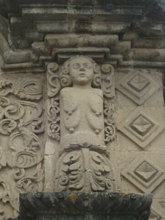 Mama Allpa peers down from her perch on the facade of a women's hospital in Cajamarca.