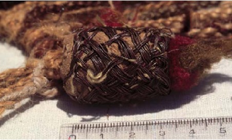 When the ayllus present their respective quipocamayos to the entire village, they twist the quipocamayo with all its pendants into a single large cable, and tie it into one huge knot. The large ornament marking the start of the record should point upward.